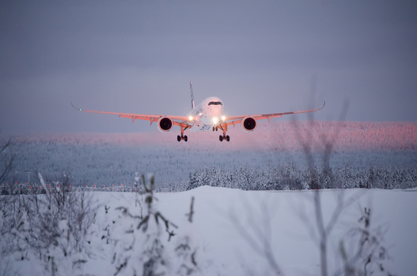 Aircraft flying over snowy landscape