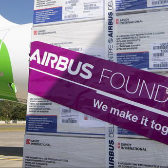 Packages with Airbus Foundation sticker in front of an airplane