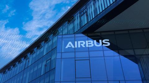 The white Airbus logo on a glass facade