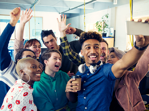 Enthusiastic business team taking selfie in office