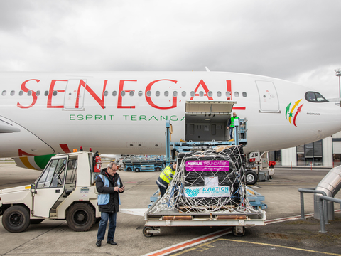 Loading relief supplies from the Airbus Foundation onto an Air Senegal aircraft.