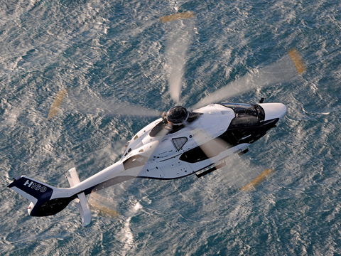 H160 flying over ocean